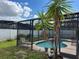 Relaxing pool area with lush landscaping and a screened enclosure at 603 Keppel Ct, Kissimmee, FL 34746