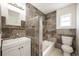 Modern bathroom with dark brown tile and a white vanity at 6150 Medford Dr, Orlando, FL 32808
