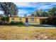 Ranch-style home with a yellow brick facade, and a spacious yard at 6150 Medford Dr, Orlando, FL 32808