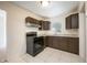 Simple kitchen with dark brown cabinets and granite countertops at 6150 Medford Dr, Orlando, FL 32808