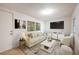 Cozy living room featuring a light colored sofa and a large TV at 6150 Medford Dr, Orlando, FL 32808