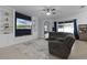 Bright living room with built-in shelving and large TV at 641 Lake Cove Pointe Cir, Winter Garden, FL 34787