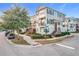 Three-story townhome with brick accents and a two-car garage at 65 Boardwalk Ave, Oviedo, FL 32765