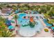An aerial view of the community pool showcasing a splashpad, water slides, lazy river, and lounge area at 8824 Bengal Ct, Kissimmee, FL 34747
