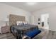 Main bedroom with tufted headboard and ensuite bathroom at 8824 Bengal Ct, Kissimmee, FL 34747