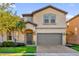 Two-story house with gray garage door and landscaping at 8824 Bengal Ct, Kissimmee, FL 34747