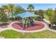 Community playground with shade structure, playset, and safety surface at 8824 Bengal Ct, Kissimmee, FL 34747