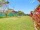 Large backyard with green grass and tropical plants at 936 Gillingham Ct, Kissimmee, FL 34758