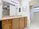 Bathroom with wood cabinets and a separate shower at 936 Gillingham Ct, Kissimmee, FL 34758