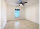 Well-lit bedroom with tile floors and a window at 936 Gillingham Ct, Kissimmee, FL 34758