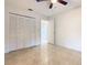 Bedroom with tile floors, a closet, and access to a bathroom at 936 Gillingham Ct, Kissimmee, FL 34758