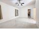 Bedroom with tile floors, a ceiling fan, and access to kitchen at 936 Gillingham Ct, Kissimmee, FL 34758