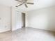 Spacious bedroom with tile floors and a double door closet at 936 Gillingham Ct, Kissimmee, FL 34758