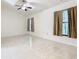 Well-lit bedroom with tile floors and two windows at 936 Gillingham Ct, Kissimmee, FL 34758