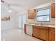 Bright kitchen with wood cabinets, granite countertops, and tile flooring at 936 Gillingham Ct, Kissimmee, FL 34758