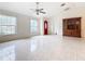 Living room with tile floors, red front door and built-in hutch at 936 Gillingham Ct, Kissimmee, FL 34758