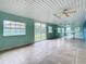 Spacious screened porch with tile flooring and ceiling fan at 936 Gillingham Ct, Kissimmee, FL 34758