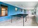 Relaxing screened porch with ping pong table and tile floor at 936 Gillingham Ct, Kissimmee, FL 34758