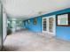 Bright blue screened porch features tile floors and French doors at 936 Gillingham Ct, Kissimmee, FL 34758