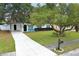 House with driveway and large yard, surrounded by lush trees at 992 Carnation Dr, Winter Park, FL 32792