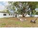 Large backyard with mature tree and fire pit at 992 Carnation Dr, Winter Park, FL 32792