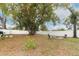 Large backyard with mature tree and fire pit at 992 Carnation Dr, Winter Park, FL 32792