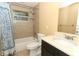 Updated bathroom with tub, shower, and dark vanity at 992 Carnation Dr, Winter Park, FL 32792