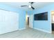 Spacious bedroom with light blue walls, ceiling fan, and large closet at 992 Carnation Dr, Winter Park, FL 32792