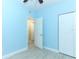 Light blue bedroom with wood-look floors and double closets at 992 Carnation Dr, Winter Park, FL 32792