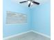 Light blue bedroom with wood-look floors and window with blinds at 992 Carnation Dr, Winter Park, FL 32792