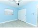 Light blue bedroom with wood-look floors and window with blinds at 992 Carnation Dr, Winter Park, FL 32792