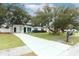 Mid-century modern home with landscaped yard, driveway, and updated exterior at 992 Carnation Dr, Winter Park, FL 32792