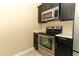 Stainless steel appliances and dark wood cabinets at 992 Carnation Dr, Winter Park, FL 32792