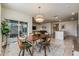 Casual dining area with wood table and chairs, open to kitchen and living room at 1016 Brooklet Dr, Davenport, FL 33837