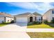 One-story home with a two-car garage and landscaped front yard at 1016 Brooklet Dr, Davenport, FL 33837