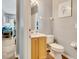Small bathroom with toilet, sink, and light wood vanity at 120 Palermo St, Davenport, FL 33897