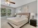 Main bedroom with king-size bed and large window at 120 Palermo St, Davenport, FL 33897