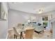 Bright dining area with glass table and seating for four, adjacent to living room at 120 Palermo St, Davenport, FL 33897