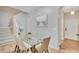 Dining area with glass-top table and chairs, view of entryway and stairs at 120 Palermo St, Davenport, FL 33897