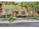 Tan two-story townhome with a landscaped front yard and brick paver driveway at 120 Palermo St, Davenport, FL 33897