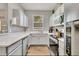 Modern kitchen with white cabinets, ample counter space and stainless steel appliances at 120 Palermo St, Davenport, FL 33897
