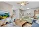 Spacious living room with light walls, comfortable sofas, and a large TV at 120 Palermo St, Davenport, FL 33897