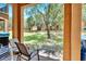 Covered patio with seating, overlooking green space at 120 Palermo St, Davenport, FL 33897