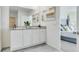 Modern bathroom with double vanity, granite countertop, and white cabinets at 1324 Hanoverian Dr, Lake Alfred, FL 33850
