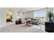 Spacious living room featuring a comfortable sectional sofa and access to a bedroom at 1324 Hanoverian Dr, Lake Alfred, FL 33850