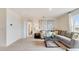 Bright living room with grey sectional sofa and large window at 1324 Hanoverian Dr, Lake Alfred, FL 33850