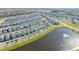 Aerial view of community with lake and homes at 14025 Kauai Dr, Orlando, FL 32827