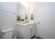 Bright bathroom featuring a vanity with white cabinets and a large mirror at 14025 Kauai Dr, Orlando, FL 32827
