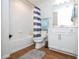 Clean bathroom, featuring a shower/tub, white cabinets and wood-look tile floor at 14025 Kauai Dr, Orlando, FL 32827