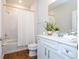 Clean bathroom with white cabinets, a shower/tub combo, and wood-look flooring at 14025 Kauai Dr, Orlando, FL 32827